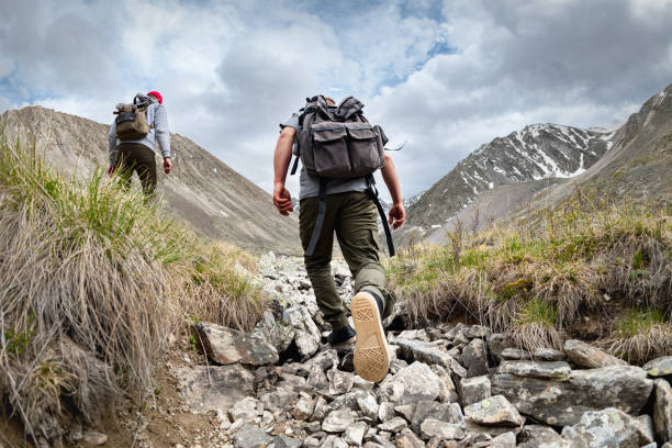 Two hikers ascending a mountain ridge — Chiri hero illustration